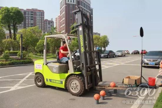 參賽選手駕駛中聯重科叉車進行“投籃”項目